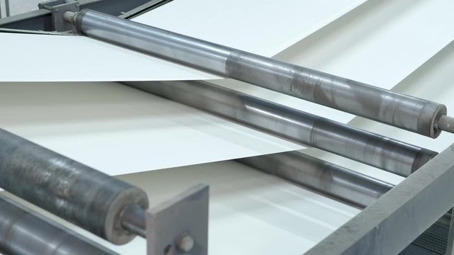 White paper rolling at high speed in a printing factory