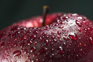 A red apple on a black background.