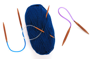 Blue yarn skein for hand knitting and crochet on white background isolated. Hat knitting process. Electric color ball of soft wool with needle. Twisted hank of thread for handmade craft. Copy space.