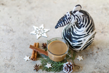 A cup of coffee next to a ceramic mouse painted under a zebra. Christmas decoration. Chinese horoscope new year greeting card concept