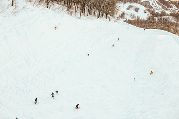 skiers and snowboarders on the track snow ski resort