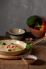 Hand uses chopsticks to pickup tasty broccoli