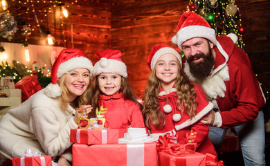 Obraz na płótnie Canvas Bearded man and mother with cute daughters christmas eve. Parents and children excited about christmas. Happy holidays. Spend time with your family. Friendly family winter vacation. Family tradition