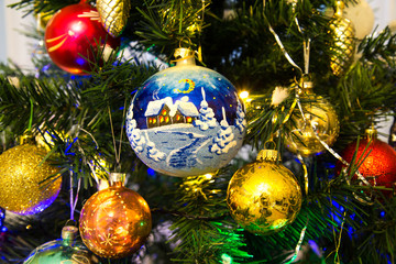 Obraz na płótnie Canvas Christmas toys yellow red blue hanging on a green Christmas tree. Holiday, Christmas, New year, toys.