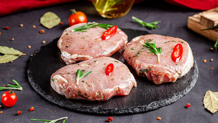 Semi-finished products. Marinated pork steak with rosemary and red chili for barbecue. Copy space, background image