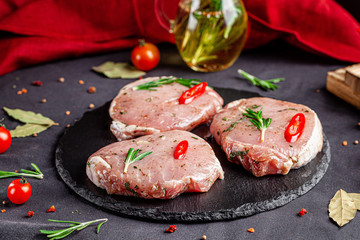 Semi-finished products. Marinated pork steak with rosemary and red chili for barbecue. Copy space, background image
