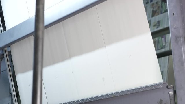 Worker takes off printing plates in press factory