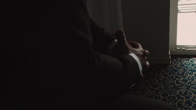 Closeup on silhouette of businessman hands in suit.