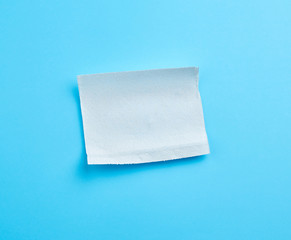 torn soft white sheet of paper towel with curled corners