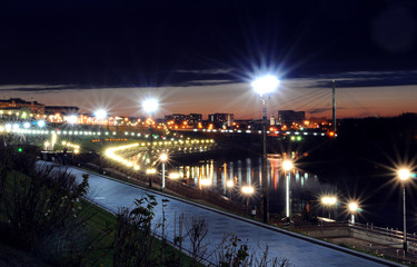 Fototapeta na wymiar travel photography, cityscape, sunset city lights, harbor and bridge over the river at night