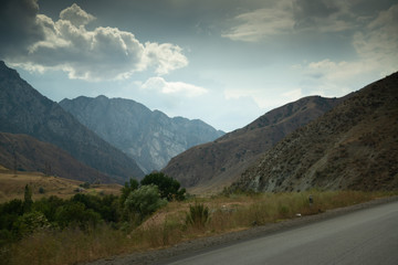 Road on the way from Bishkek to Osh with beautiful mountain range in Kyrgyzstan