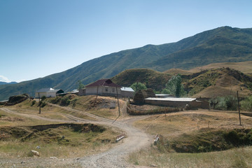 House and yurts on road trip from Osh Kyrgyzstan to Tajikistan through the Pamir highway