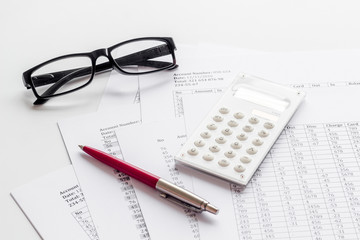 Naklejka na ściany i meble Taxes calculation concept. Financial documents, calculator, glasses on white background
