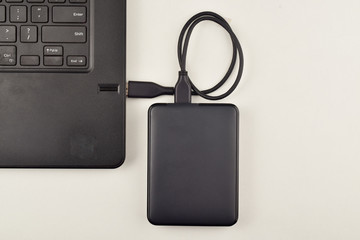 data transfers from hard disk to laptop over white background, top view