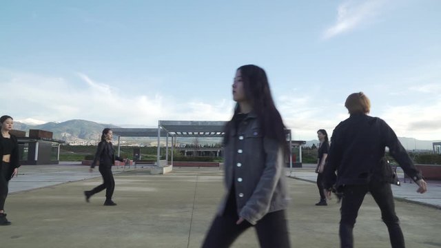 Young STREET PERFORMER performing on the street. Seven chinese teenagers dancing kpop