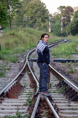 Solo traveller : Asian woman tourist is solo traveling and stand alone at railroad in train station. travel concept