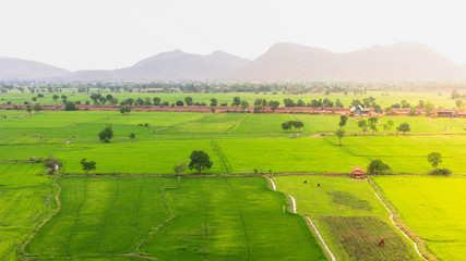 Naklejka premium Landscape of green fields and mountains at tiger Cave temple (Wat Thum Sua) the temple is beautiful and popular tourist, Kanchanaburi, Thailand 