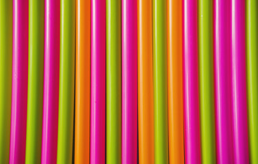 Obraz premium Colorful plastic Drink straws on blue background. Equipment for single use. Plastic pollution, waste, eco, ecology, recycle. Plastic processing problem. Close up. Flat lay