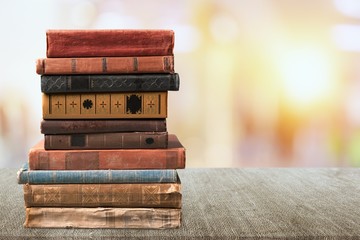 Old vintage books stacked on blur background.
