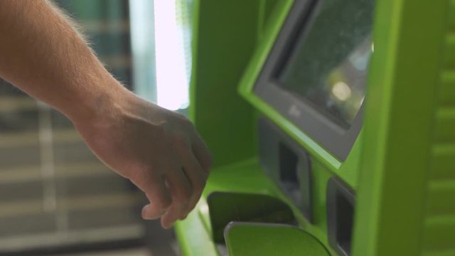 Man using atm to withdraw cash
