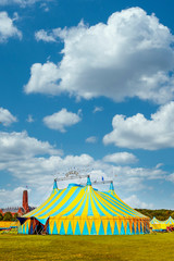Vertical view of a circus tent under a warn sunset and chaotic sky