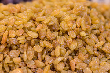 Raisins, made from yellow and green dry grapes, close-up,