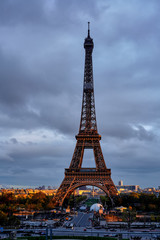 Fototapeta na wymiar Eiffel Tower in cloudy weather in the rays of the setting sun