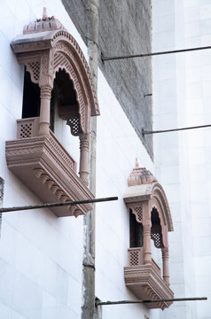 decorated windows, columns and arches in the Indian temple under construction.