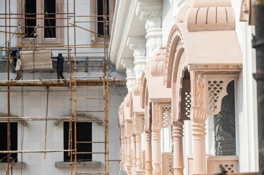 decorated windows, columns and arches in the Indian temple under construction.
