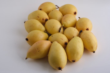 Yellow pears on white background and in the plate