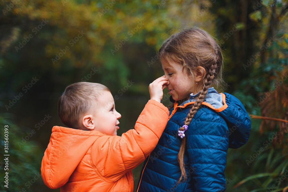 Sticker boy holding girl's nose