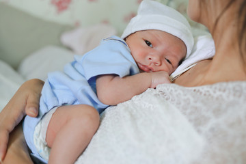 little newborn baby embracing on mother with love