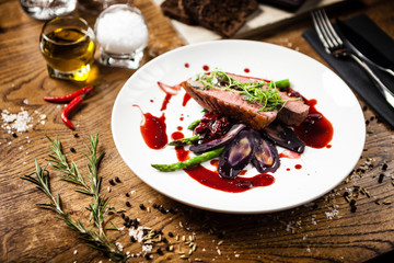 Duck breast served on a plate in restaurant