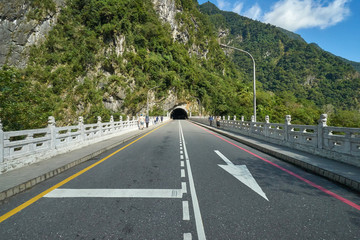 Bridge road with a mountain tunnel at the far end