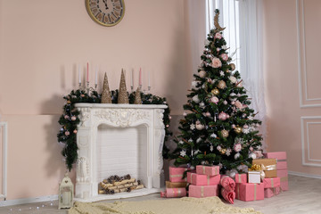 Christmas tree with a lot of gifts in the room near the fireplace.