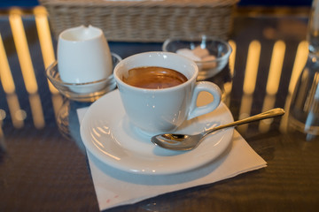 a cup of espresso on a table in a cafe