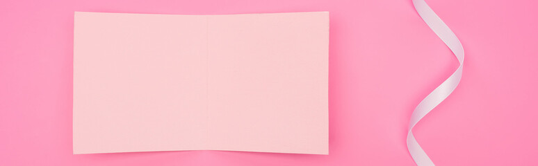 top view of empty paper card with ribbon isolated on pink, panoramic shot