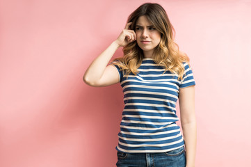 Unsure Young Female Contemplating In Studio