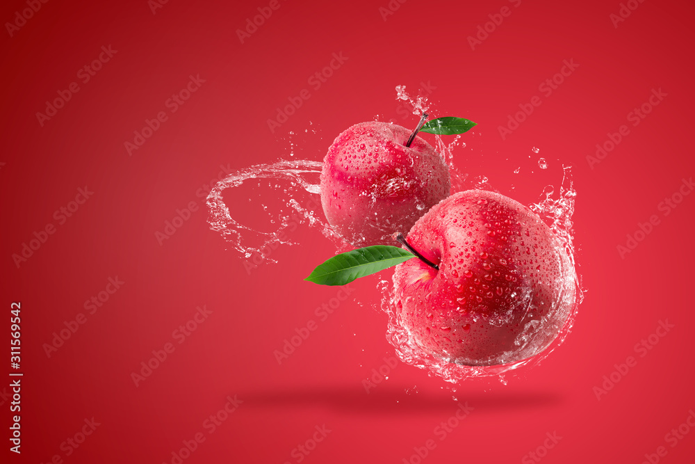 Canvas Prints water splashing on fresh red apple on red background. - Canvas Prints