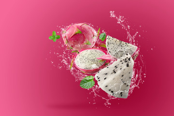 Water Splashing on Dragon Fruit or Pitaya over pink background
