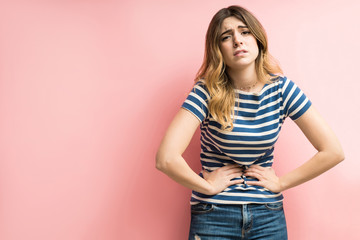 Female With Stomachache Against Colored Background