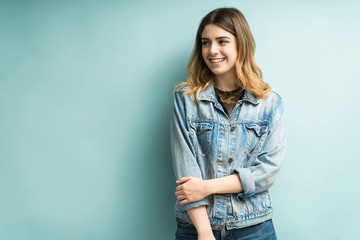 Happy Fashionable Female Standing Against Blue Background