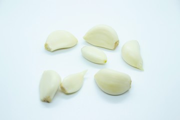 Peeled garlic located on a white background