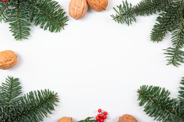 Beautiful, natural, reusable and zero waste frame composition of christmas objects such as walnuts, fresh and green pine branches.