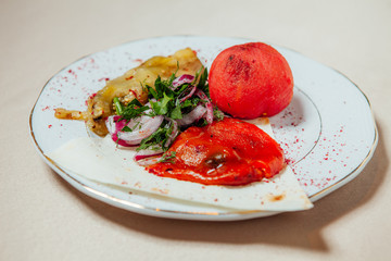 Vegetables fried on coals on a white plate