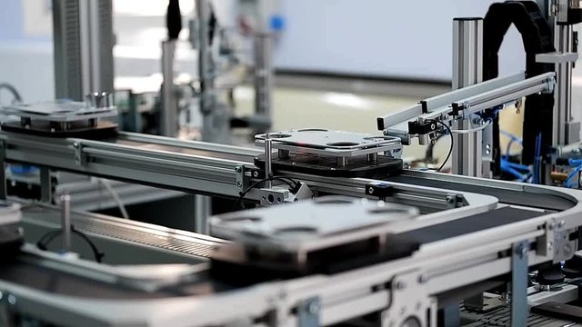 Close up of automated car is waiting to be loaded at loading station of smart factory. Industry 4.0 smart factory concept; artificial intelligence in production. Selective focus.