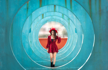 .Woman walking in the middle of the blue circle tunnel Is a parking lot used to shoot music videos...