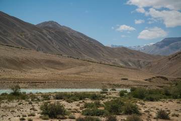 Fototapeta na wymiar View on Wakhan Corridor in Afghanistan behind the Wakhan river. Taken from Pamir highway on Tajikistan side.