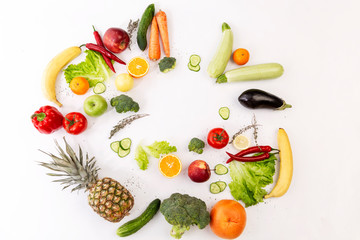 Fresh juicy vegetables and fruits beautifully laid out on a white background. Space for text.