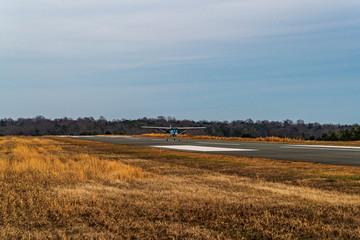 rural landscape with airplane, wheat field and blue sky